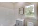 Clean bathroom with a shower/tub combo and a window overlooking the backyard at 3621 Olive Branch Rd, Greenwood, IN 46143