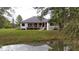 House's back features a large deck, pond, and lush green lawn at 3621 Olive Branch Rd, Greenwood, IN 46143