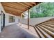 Covered patio with stairs and access to backyard at 3621 Olive Branch Rd, Greenwood, IN 46143