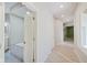 Bright hallway with hardwood floors and access to bathroom and bedroom at 3621 Olive Branch Rd, Greenwood, IN 46143