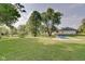 Relaxing pool area with grassy lawn and pond view at 3621 Olive Branch Rd, Greenwood, IN 46143