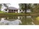 Features a large deck, pond, and lush green lawn at 3621 Olive Branch Rd, Greenwood, IN 46143
