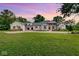 Stunning farmhouse exterior with a metal roof and landscaping at 3621 Olive Branch Rd, Greenwood, IN 46143
