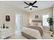 Bedroom with queen bed, ceiling fan, and access to private bath at 3621 Olive Branch Rd, Greenwood, IN 46143