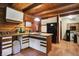Rustic kitchen with wood cabinets, island, and stainless steel appliances at 9307 E Dill Rd, Morgantown, IN 46160
