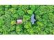 House nestled in a forest with a brown metal roof at 9307 E Dill Rd, Morgantown, IN 46160