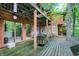 Spacious wooden deck with access to multiple rooms and wooded views at 9307 E Dill Rd, Morgantown, IN 46160