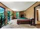 Main bedroom with a fireplace, deck access, and large windows at 9307 E Dill Rd, Morgantown, IN 46160