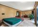 Spacious bedroom with a green bedspread and access to a deck at 9307 E Dill Rd, Morgantown, IN 46160