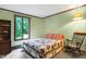 Bedroom with a rocking chair and a view of the backyard at 9307 E Dill Rd, Morgantown, IN 46160