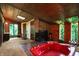 Bathroom with a red jacuzzi tub, fireplace, and wood details at 9307 E Dill Rd, Morgantown, IN 46160