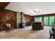 Cozy living area with wood-paneled walls, a wood stove, and relaxing seating at 9307 E Dill Rd, Morgantown, IN 46160