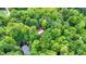 House nestled in a forest with a brown metal roof at 9307 E Dill Rd, Morgantown, IN 46160