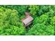 House nestled in a forest with a brown metal roof at 9307 E Dill Rd, Morgantown, IN 46160