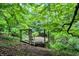 Rustic deck overlooking a pond, nestled in lush greenery at 9307 E Dill Rd, Morgantown, IN 46160