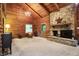 Cozy living room with stone fireplace and vaulted, wood-beamed ceiling at 9307 E Dill Rd, Morgantown, IN 46160