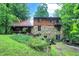 Two story home with stone and wood exterior, nestled in woods at 9307 E Dill Rd, Morgantown, IN 46160