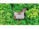 House nestled in a forest with a brown metal roof at 9307 E Dill Rd, Morgantown, IN 46160