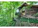 Log cabin home nestled in a lush forest setting at 9307 E Dill Rd, Morgantown, IN 46160