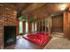 Bathroom with a red jacuzzi tub and brick fireplace at 9307 E Dill Rd, Morgantown, IN 46160