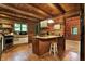 Rustic kitchen with wood cabinets, island, and stainless steel appliances at 9307 E Dill Rd, Morgantown, IN 46160