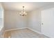 Spacious dining area with tile floors and a modern chandelier at 975 Rolling Hill Rd, Greenwood, IN 46142