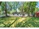 Large backyard with a grassy lawn and mature trees at 975 Rolling Hill Rd, Greenwood, IN 46142