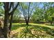 Large backyard with mature trees and a wooden fence at 975 Rolling Hill Rd, Greenwood, IN 46142
