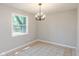 Simple dining room with tiled floors and a chandelier at 975 Rolling Hill Rd, Greenwood, IN 46142
