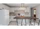 Eat-in kitchen with white cabinets, island, and tile backsplash at 975 Rolling Hill Rd, Greenwood, IN 46142