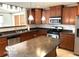 Kitchen with wood cabinets, granite countertops, and island at 10429 Serviceberry Dr, Avon, IN 46123