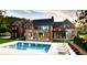 Luxury home with a large pool and outdoor seating area at 9700 Windy Hills Dr, Zionsville, IN 46077