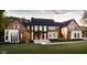 Luxury home with modern design, stone accents, and a large yard at 9700 Windy Hills Dr, Zionsville, IN 46077