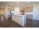 Modern kitchen with island, stainless steel appliances, and hardwood floors at 5858 Handbell Ln, Greenwood, IN 46143