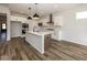 Modern kitchen with white cabinets, island, and stainless steel appliances at 9227 Brookview Ave, McCordsville, IN 46055