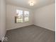 Well-lit bedroom with grey carpet and window views at 9227 Brookview Ave, McCordsville, IN 46055