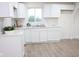 White kitchen with hexagon tile and double sink at 4126 W 30Th St, Indianapolis, IN 46222