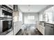 Modern kitchen with white cabinets, farmhouse sink, and stainless steel appliances at 441 W 86Th St, Indianapolis, IN 46260