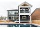 Two-story house with a dark exterior, deck, and inground pool at 441 W 86Th St, Indianapolis, IN 46260