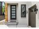 Modern front entrance with black door, wood post, and glass panels at 441 W 86Th St, Indianapolis, IN 46260