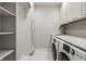 Bright laundry room with built-in cabinets, shelving, and modern washer/dryer at 441 W 86Th St, Indianapolis, IN 46260