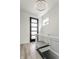 Bright entryway with modern staircase, glass railing, and hardwood floors at 441 W 86Th St, Indianapolis, IN 46260