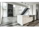 Open concept kitchen with white cabinets, island, and stainless steel appliances at 441 W 86Th St, Indianapolis, IN 46260