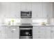 White shaker cabinets, granite countertops, and stainless steel appliances at 437 W 86Th St, Indianapolis, IN 46260
