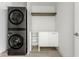 Laundry room with LG washer and dryer, white cabinets, and additional shelving at 437 W 86Th St, Indianapolis, IN 46260