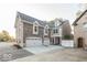 Brick house with a three-car garage and large driveway at 437 W 86Th St, Indianapolis, IN 46260