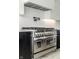 Stainless steel range with double oven and black cabinetry in a modern kitchen at 437 W 86Th St, Indianapolis, IN 46260