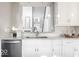 Kitchen with white cabinets, granite counters, and a view into the living area at 437 W 86Th St, Indianapolis, IN 46260