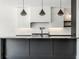 Modern kitchen with sleek dark cabinetry, quartz countertops, and contemporary pendant lighting at 437 W 86Th St, Indianapolis, IN 46260