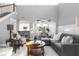 Open living room featuring a sectional sofa, coffee table, and access to the kitchen and dining area at 437 W 86Th St, Indianapolis, IN 46260